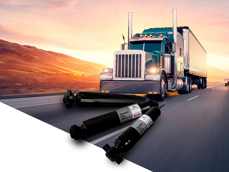 Amortiguadores Meritor con un tractocamión en movimiento al fondo.